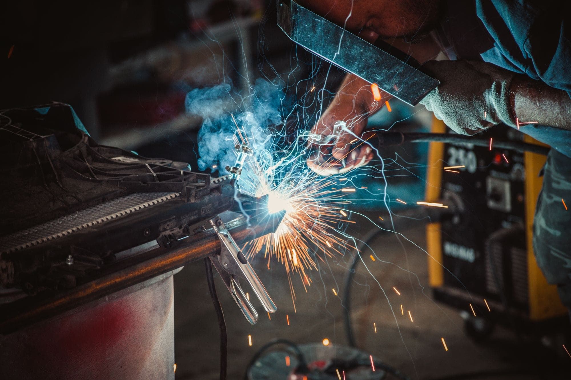 Close-up of a welder at work with sparks